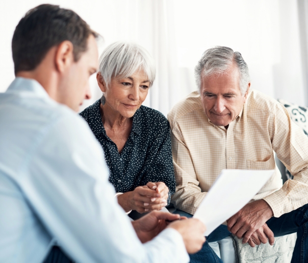 Couple reviewing finances with advisor